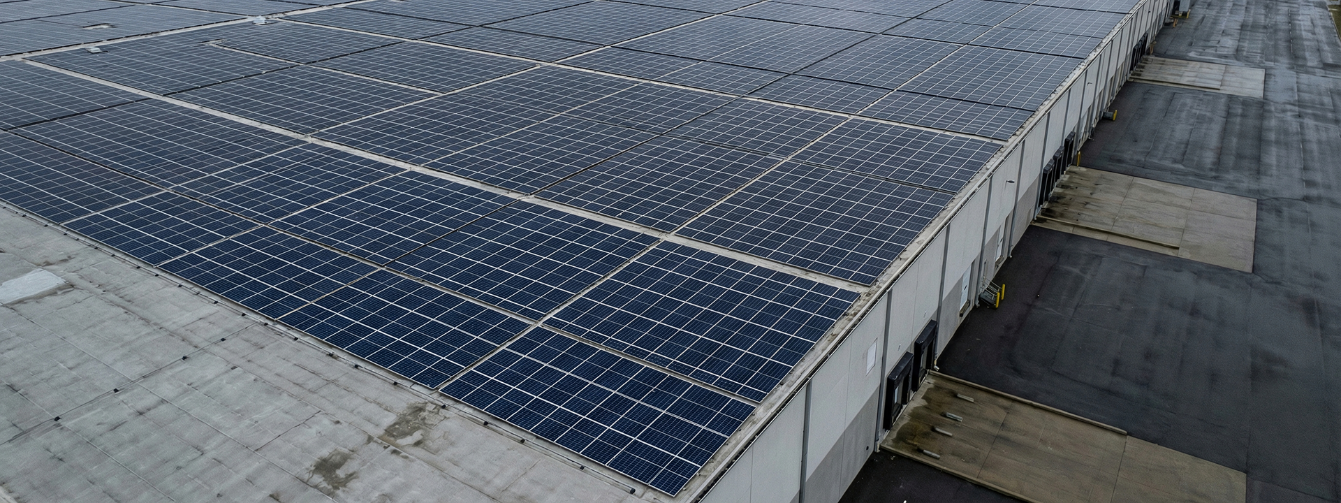 Solar panels installed on the roof of an industrial building.
